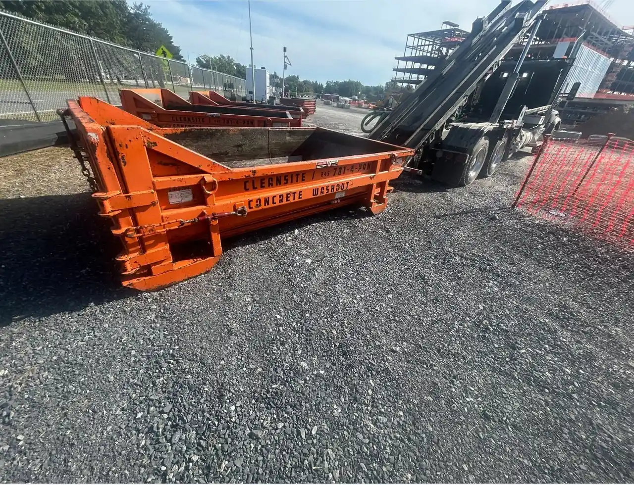CleanSite truck picking up a concrete washout container from a job site