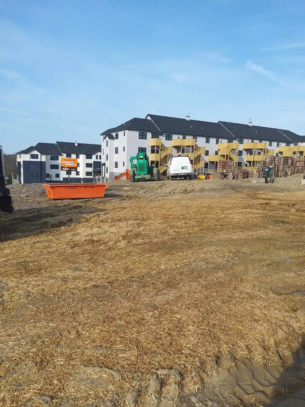 CleanSite pan on a field near apartment buildings