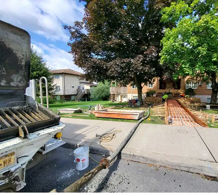 Pump hopper set over a CleanSite washout pan on a residential street
