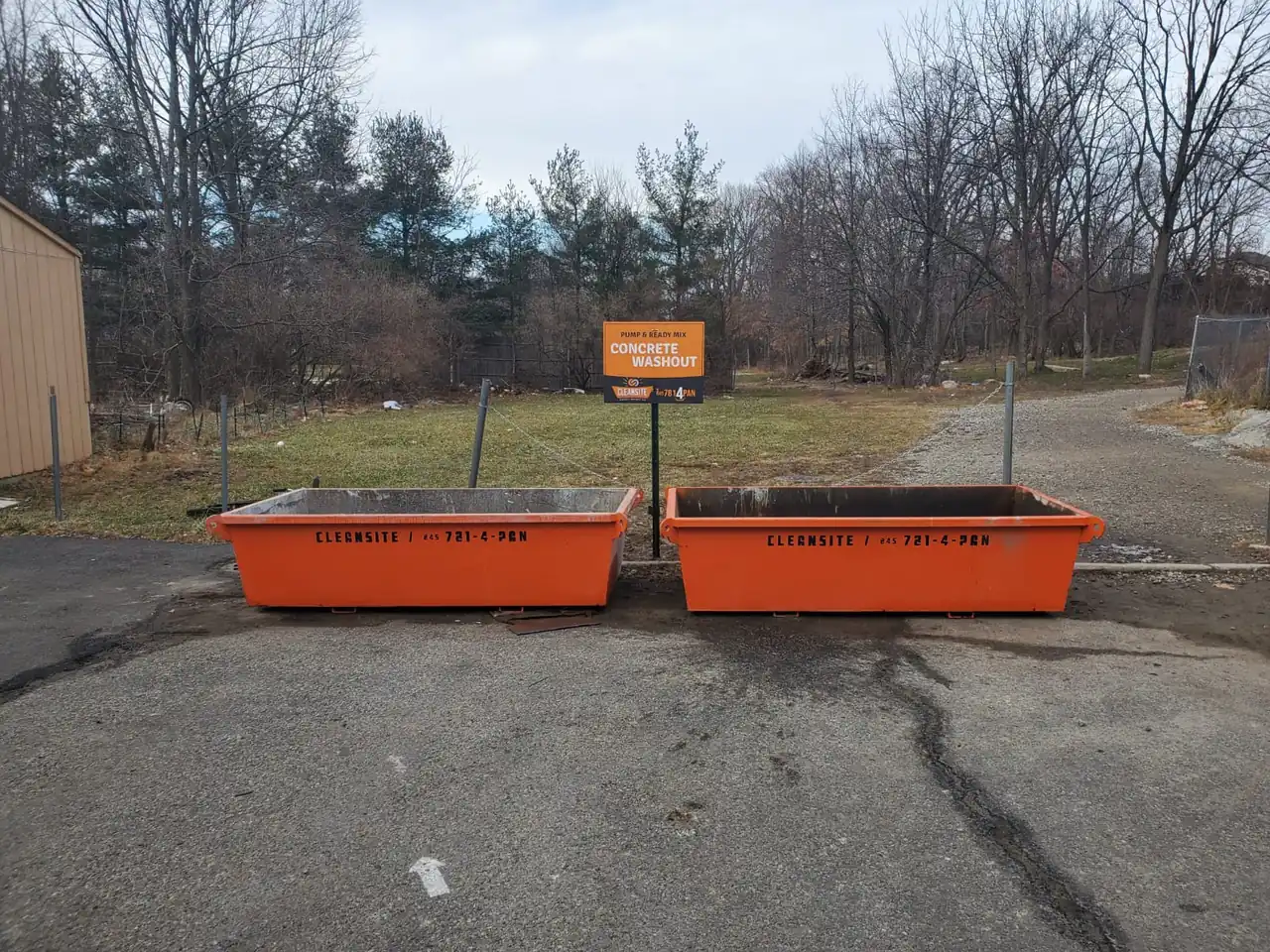 Two CleanSite pans at the edge of a paved job site