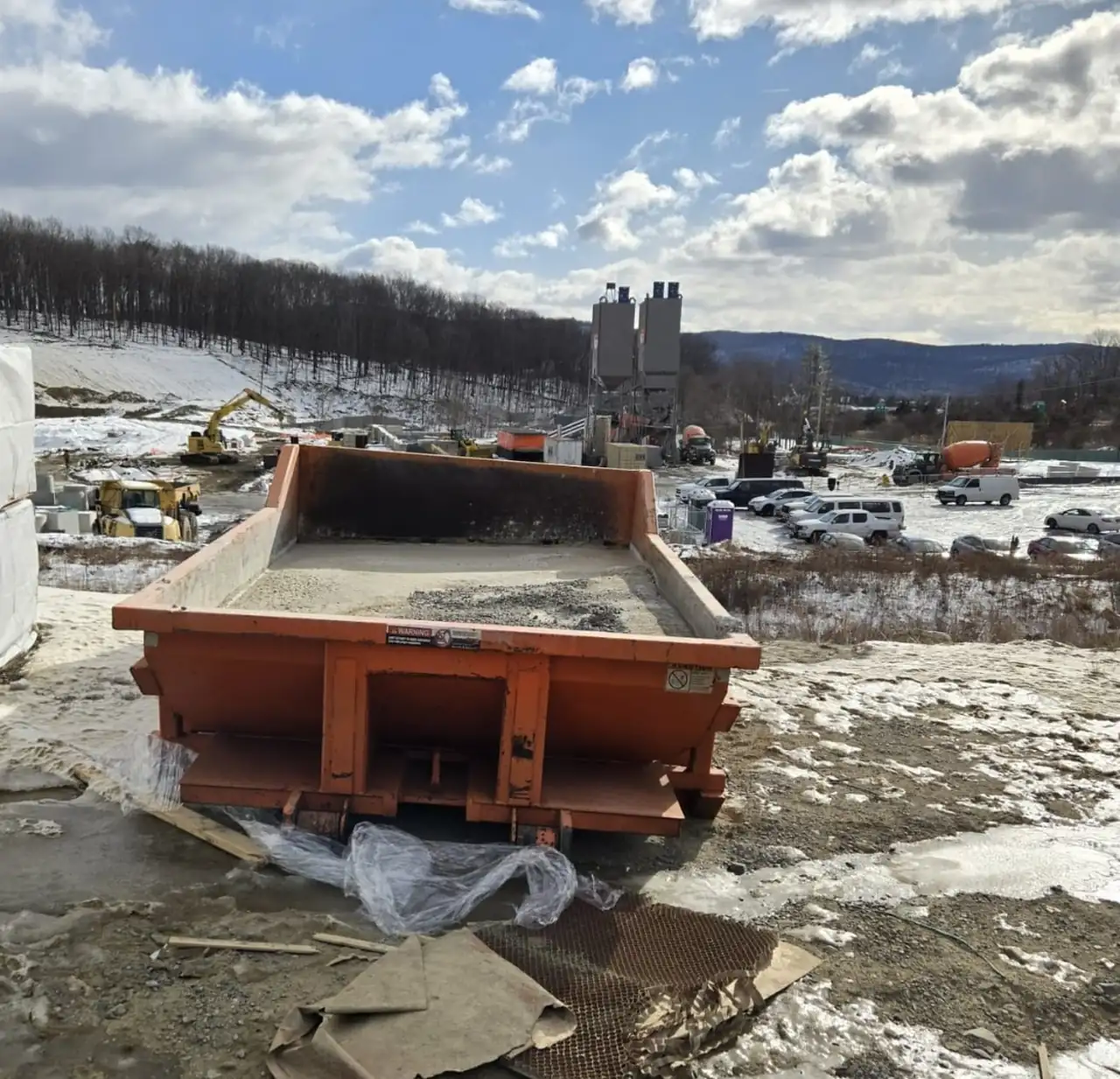 CleanSite washout container holding washout on a muddy winter job site