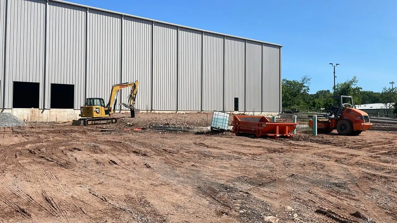 CleanSite washout container next to a new warehouse under construction