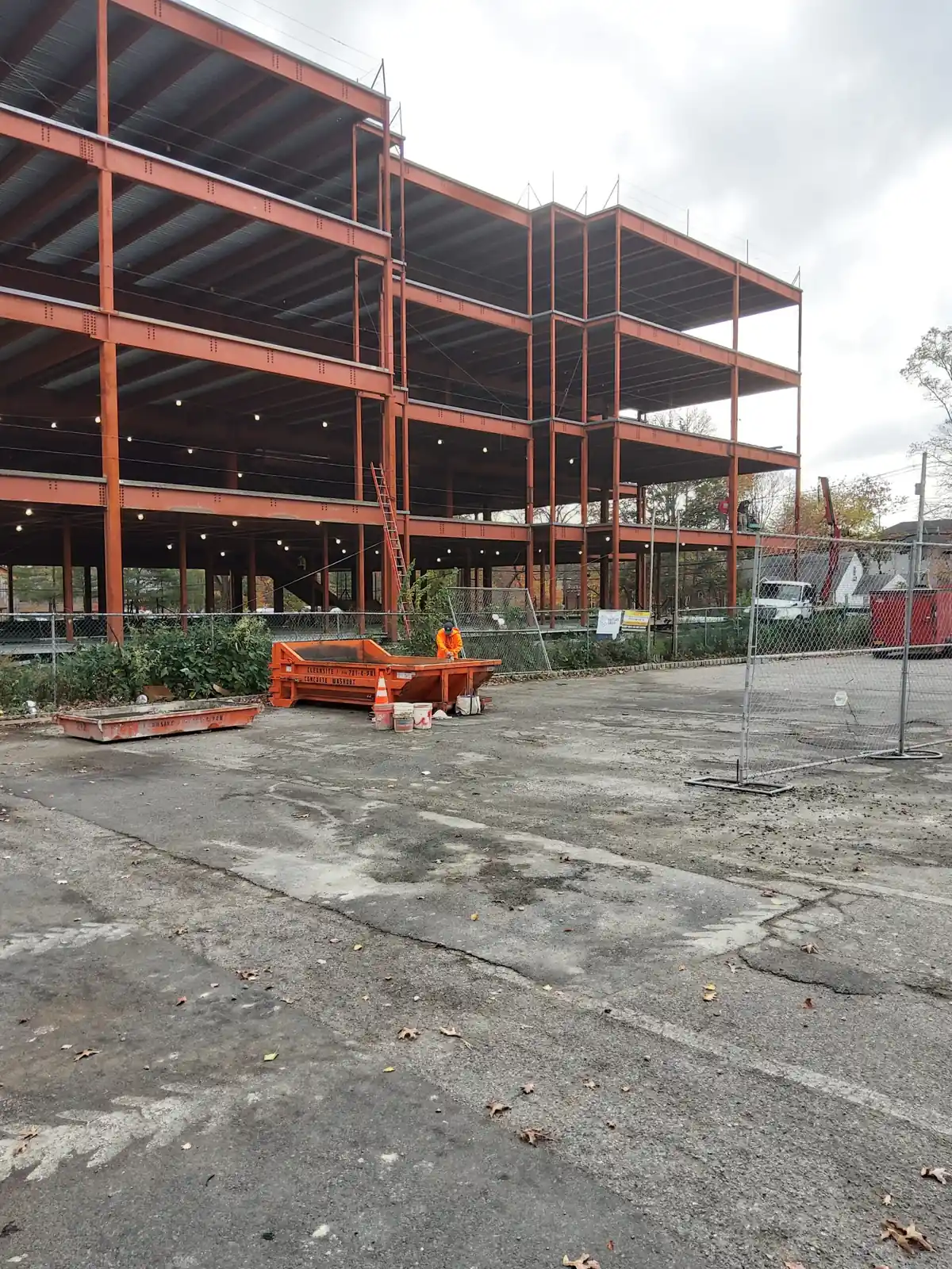 CleanSite washout pans at the base of a steel-frame commercial building